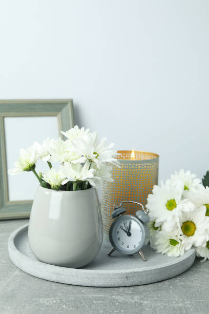 istock Beautiful composition with white chrysanthemums on gray textured table 1495150278