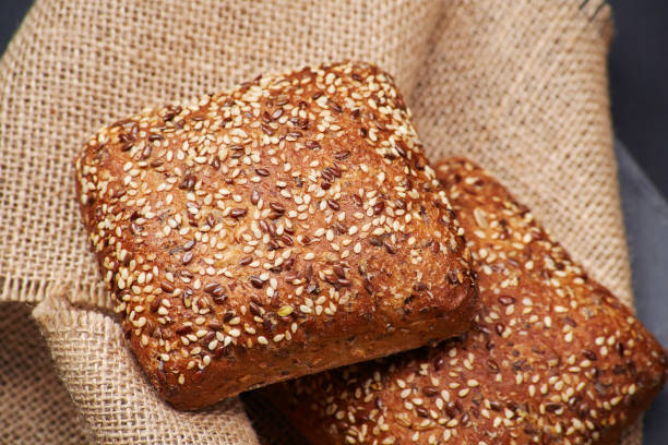 istock Freshly baked rustic bread buns with sesame seeds 1495150776