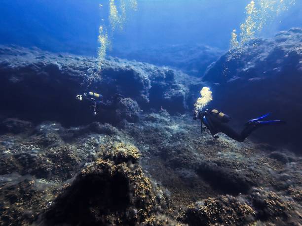 istock Scuba diver in a volcanic underwater landscape 1495152817