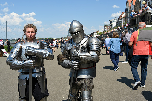 Epic Invading Army of Medieval Knights on Battlefield, Plate Body Armored Soldiers Hit Shields with Swords in Battle Cry. War and Conquest. Historical Reenactment.
