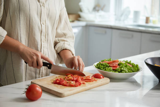 istock Housewife Cutting Juicy Tomatoes 1495156287