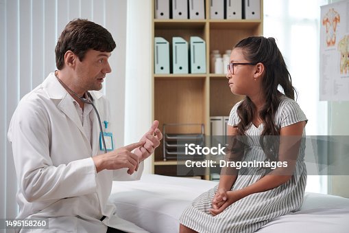 istock Pediatrician Talking to Girl 1495158260