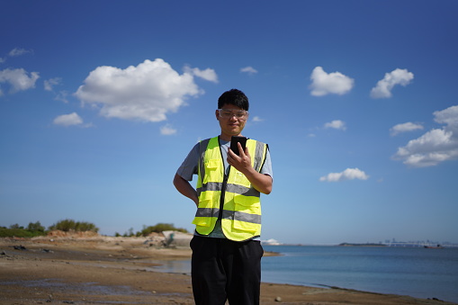 Engineer using smart device at the beach