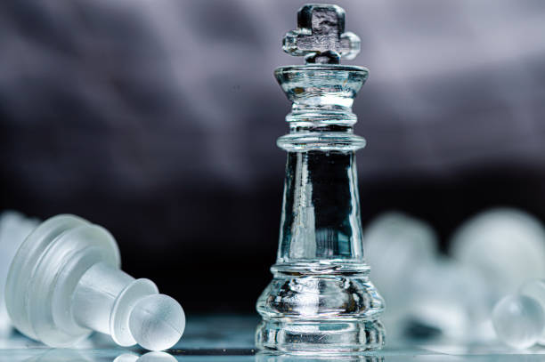 istock glass chess board game in black background ,selective focus on King, leadership concept 1495161448