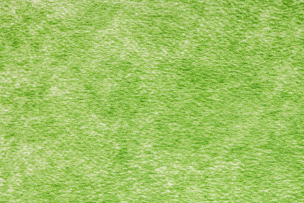 Close-up of a vibrant green towel texture, showcasing plush fibers and rich color. Perfect for backgrounds or textile designs.