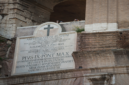 Rome Italy - April 16 2011; Detail on marble plaque l outside Colosseum in Rome placed by Pope Benedict XIV pope referring to and to dedicated to Christian martyrs