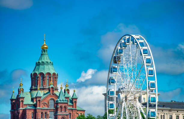 Helsinki, Finland - July 4, 2017: Uspenski Cathedral and Ferris Wheel.