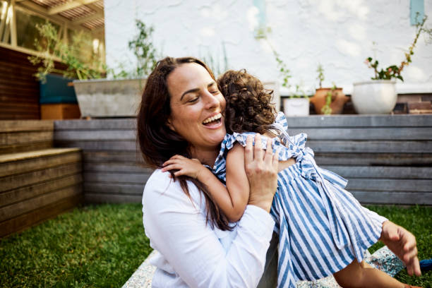 istock A Young Child Embracing Her Mother in the Backyard 1495163835
