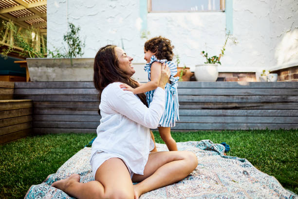 istock A Young Child Embracing Her Mother in the Backyard 1495163836
