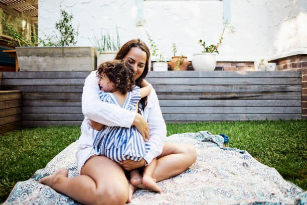 istock A Young Child Embracing Her Mother in the Backyard 1495163840
