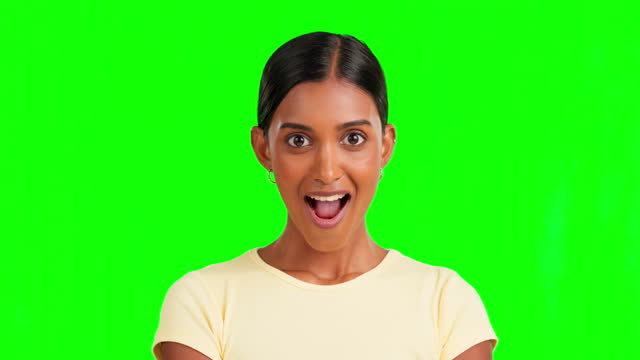 Indian woman, shock and wow face by green screen for hearing secret, info and news by background. Girl, young model and portrait with surprise facial expression for gossip, discussion and confused