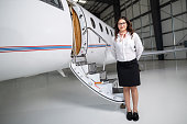 Air Hostess Standing Next To Private Jet