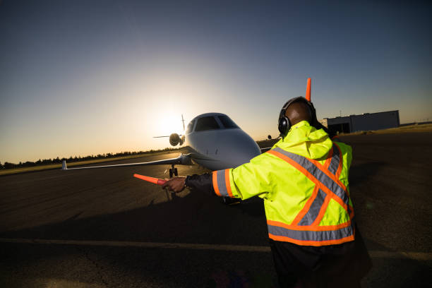 istock African American Ground Crew Signaling Private Jet 1495164765