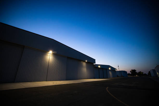 istock Airplane Hangar At Dusk 1495164857