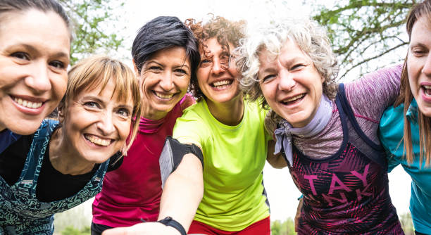 happy multi generational women having fun together at city park - multigenerational female friends taking selfie after sport workout outdoor - bright filter with focus on faces - senior adult sport yoga exercising imagens e fotografias de stock