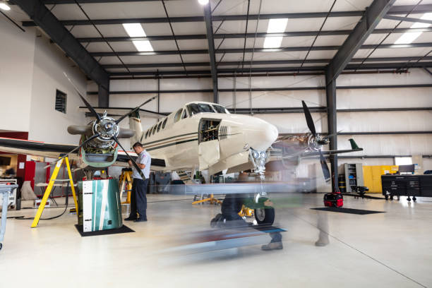 istock Mechanics In Hangar On Turboprop Plane 1495165035