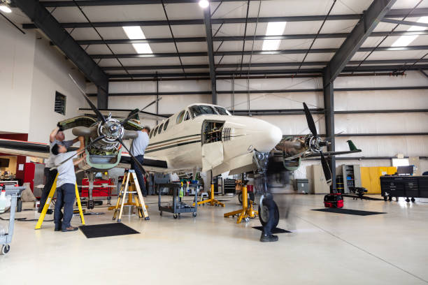 A turboprop plane undergoing maintenance inside the hangar of a small general aviation airport in California.
