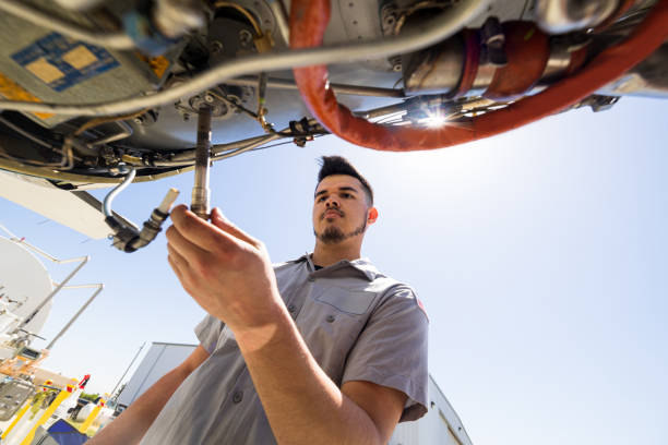 istock Young Airplane Mechanic Working On Private Jet During The Day 1495165070