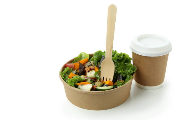 Pumpkin salad and coffee in disposable tableware isolated on white background