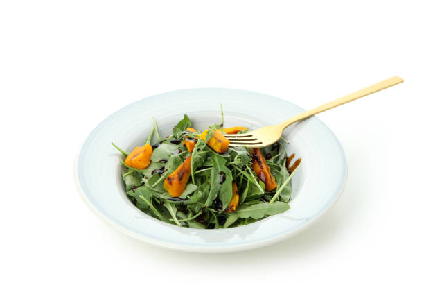 Plate with pumpkin salad isolated on white background
