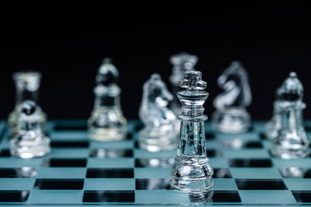 istock glass chess board game in black background ,selective focus on King, winner concept 1495166809