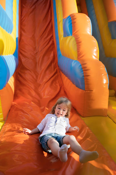 istock Little kid having fun in inflatable castle playground 1495166817