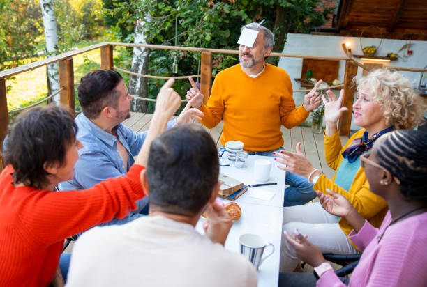 istock Multiethnic mature friends Playing Guessing game 1495170467