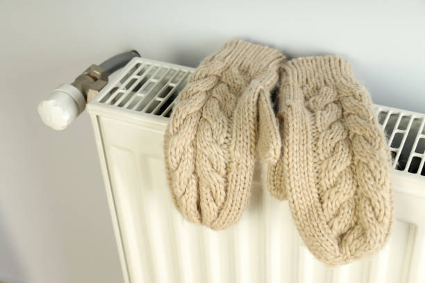 istock Concept of heating season with mittens on radiator 1495170939