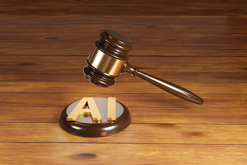 Wooden gavel with brass engraving band and golden alphabets AI on a round wood sound block. Illustration of the concept of legislation of artificial intelligence act and rules