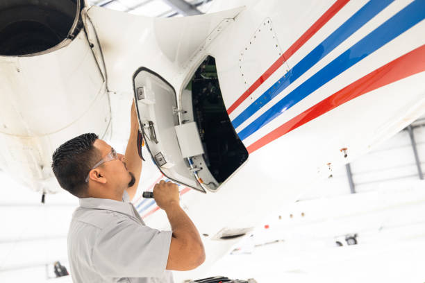 istock Mechanic Performing Maintenance On Private Jet 1495170965