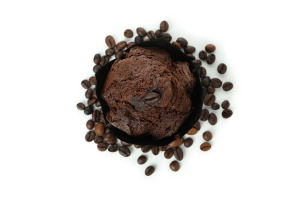 Chocolate muffin with coffee seeds isolated on white background.