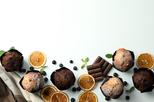 Concept of delicious food with chocolate muffins on white background.