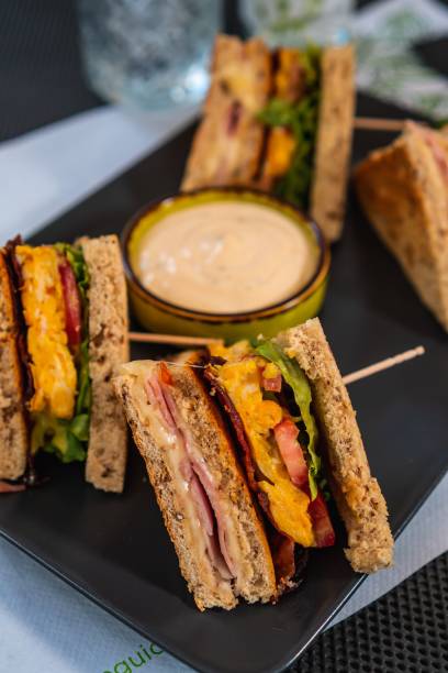 istock a sandwich is on a black plate next to some dipping 1495173063