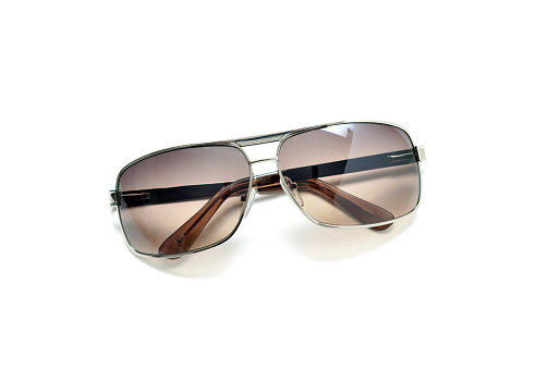 Closeup of generic, mass produced sunglasses on a white background.