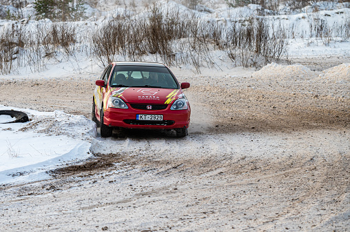 Tukums, Latvia - January. 7. 2023: Young people practice safe driving on a winter track with a sports car