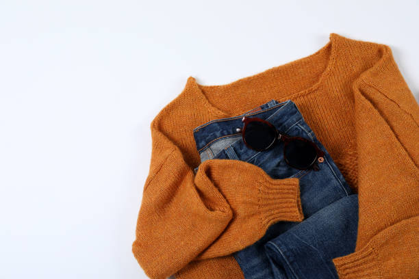 High Angle View Of Clothes And Sunglasses On Table