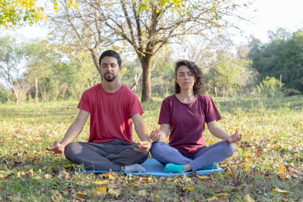 istock man and woman stretching and doing meditation 1495177645
