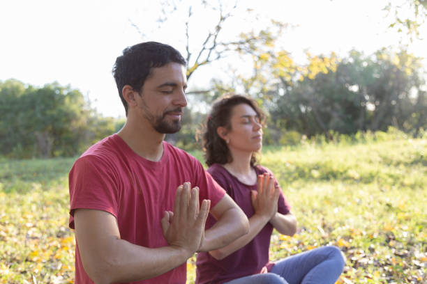 istock man and woman stretching and doing meditation 1495177689