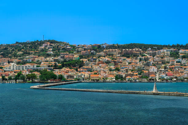 1813 stone-built water-surrounded obelisk next to De Bosset Bridge with Argostoli town panorama in the background on the Ionian Island of Cephalonia Greece. stock photo