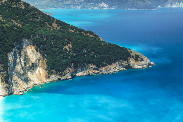 Crystal clear Myrtos beach with turquoise waters surrounding a cliff at Cephalonia Ionian Island Greece. stock photo