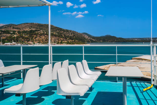istock White empty plastic fiberglass chairs and seating area with tables on a ferry boat under a bright summer sky. 1495178221