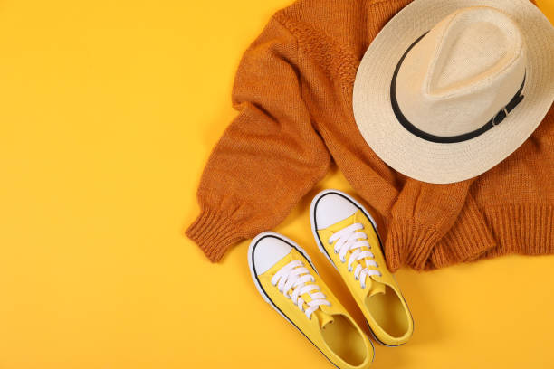 istock Sweater, sneakers and hat on yellow background 1495178330
