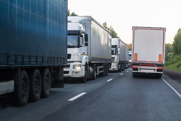 istock Trucks move in opposite directions on a suburban highway 1495179692