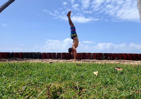 Man Shows Off Handstand Skills at Leahi Beach Park on Oahu, Hawaii.