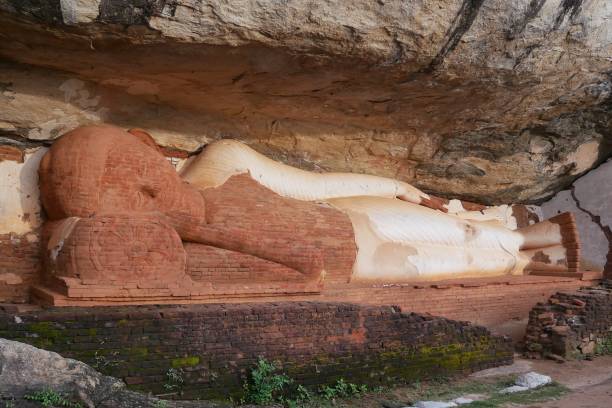 istock Faded and worn red brick statue of the reclining Buddha 1495181276