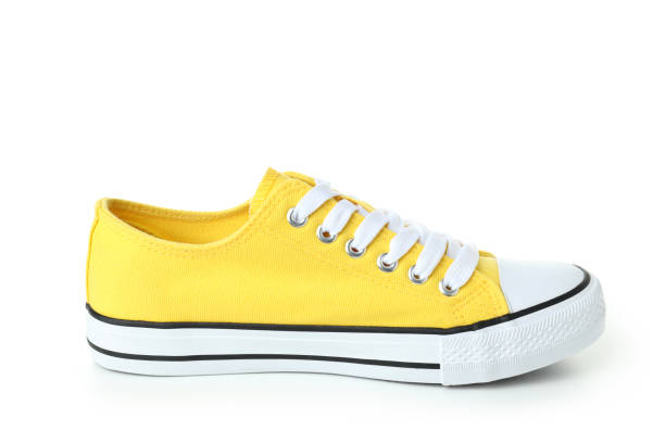 istock Pair of yellow sneakers isolated on white background 1495182741