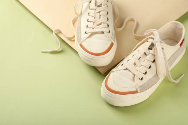 istock Pair of beige sneakers on two tone background 1495182830