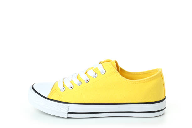 istock One yellow sneaker isolated on white background 1495182860