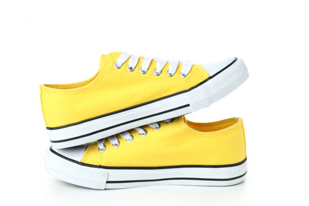 istock Pair of yellow sneakers isolated on white background 1495183140