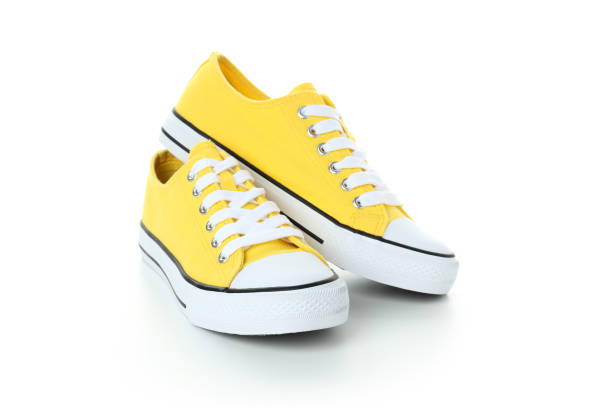 istock Pair of yellow sneakers isolated on white background 1495183914